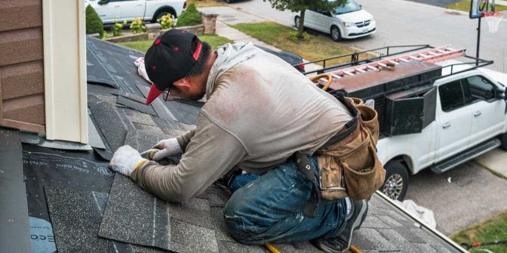 A man installing a new roof.